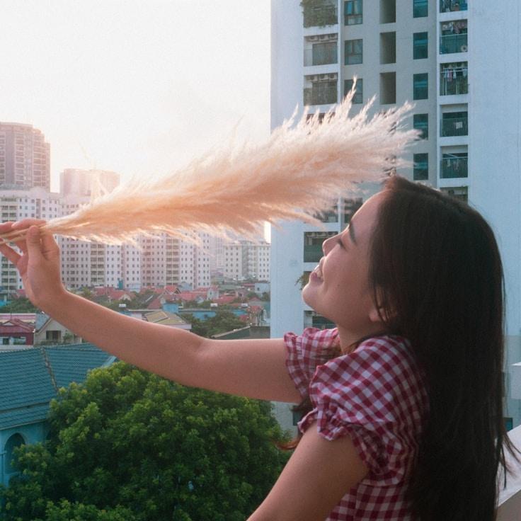 Kaveri Mehta, Lead Design Curator at Murmur Oak Meadow, reviewing corporate floral arrangements